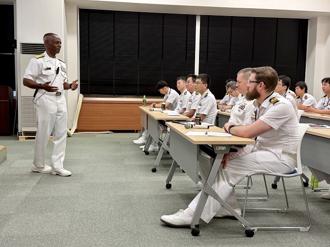 A man speaking to a group of students in a classroom